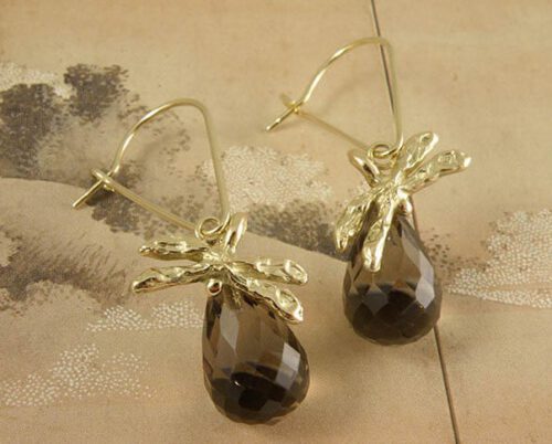 Geelgouden lange oorhaken met rookkwarts en een libelle. Yellow golden long earrings with smokey quartz and a dragonfly. Uit het Oogst atelier Amsterdam.