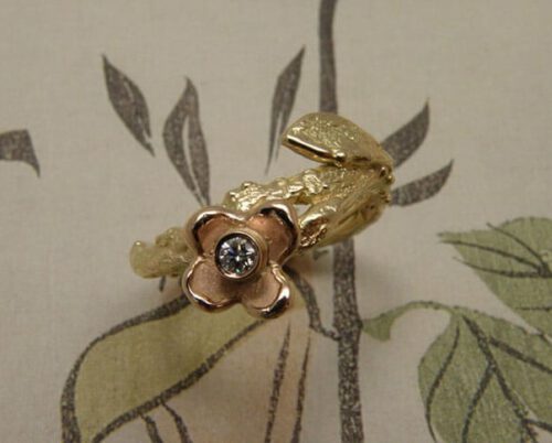Roségouden Boomgaard ring, bloem, takje met blaadje en diamant. Maatwerk uit het Oogst atelier. Rosé gold ring Orchard, twig with leaf, flower and diamond. Custom design made in the Oogst goldsmith studio.