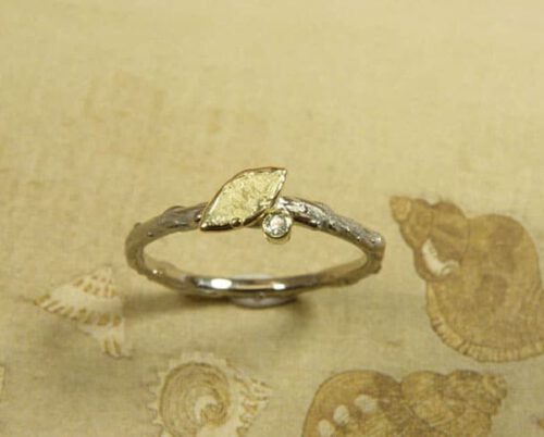 Engagement ring 'Orchard'. White golden twig ring with yellow golden leaf and a 0,02 crt diamond. Created in the Oogst studio in Amsterdam.