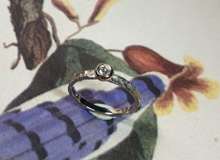 Engagement ring 'Swell'. White golden ring with texture and 0,10 ct diamond. Made at Oogst studio. Blog the perfect engagement ring – the 6 most frequently asked questions