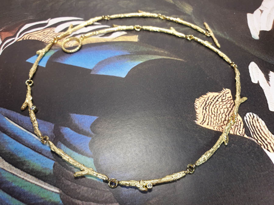 Yellow gold necklace Orchard, refined twigs with diamonds. Oogst goldsmith Amsterdam atelier. Blog about the Oogst craftswomanship.