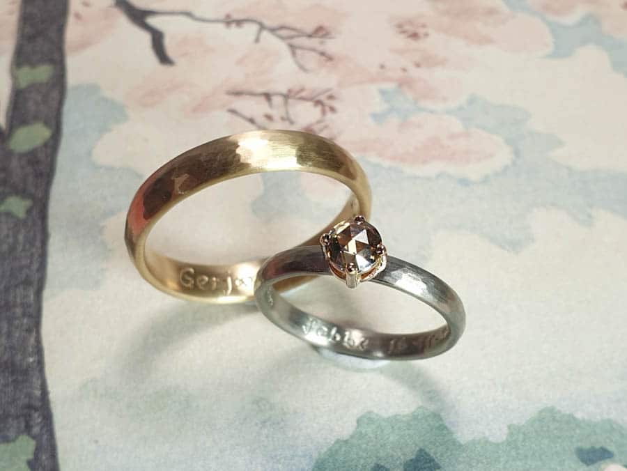Wedding rings Rhythm, white gold ring with a rose cut brown diamond and rose gold hammered ring. Goldsmith Oogst Amsterdam. Blog about the Oogst craftswomanship.