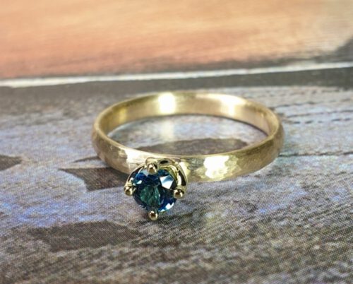 Yellow gold engagement ring with hammering and topaz. Design by Oogst, goldsmith studio in Amsterdam
