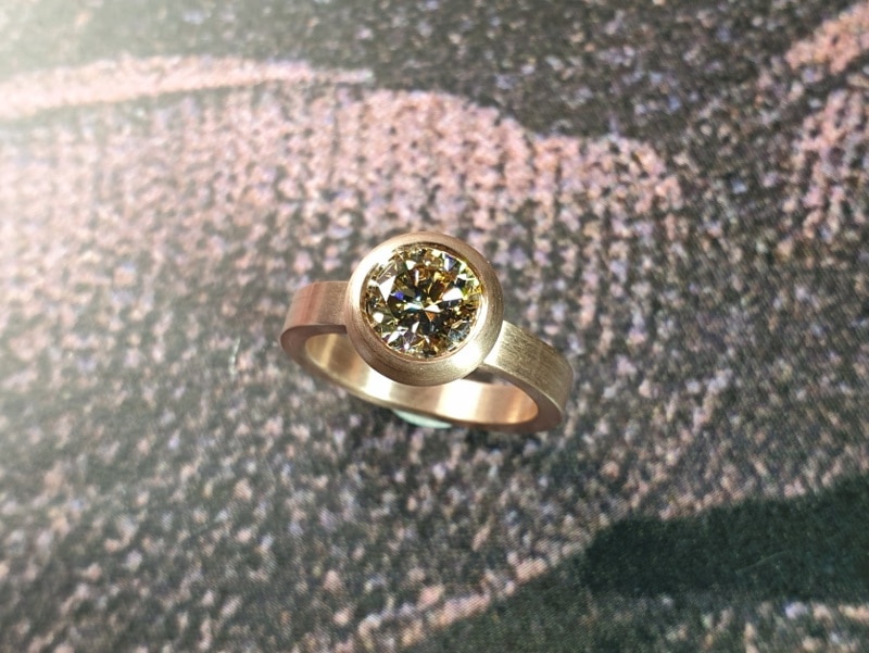 engagement ring 'Boletus' . Rose gold ring with a 1,5 ct brilliant cut diamond natural light amber in a full bodied setting. Design by Oogst Jewellery