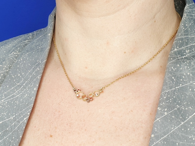 Yellow gold 'Cloud' necklace is made with sleek yellow, rose and white gold shapes and sparkly diamonds. Designed by Oogst goldsmith Amsterdam.