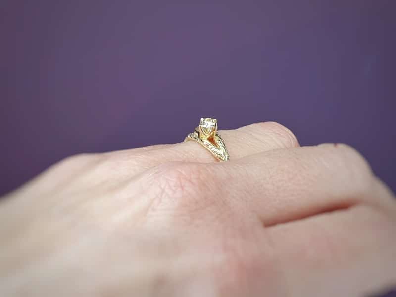 Engagement ring yellow gold twig with a diamond. From the Orchard series. Design by Oogst Goldsmith in Amsterdam. Seen on the hand.