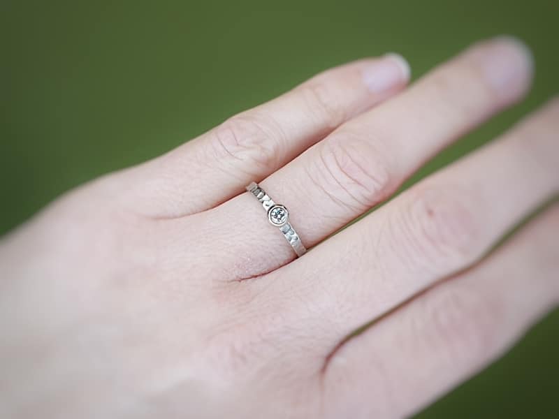 Engagement ring 'Swell'. White golden ring with texture and 0,10 ct diamond. Made at Oogst studio.
