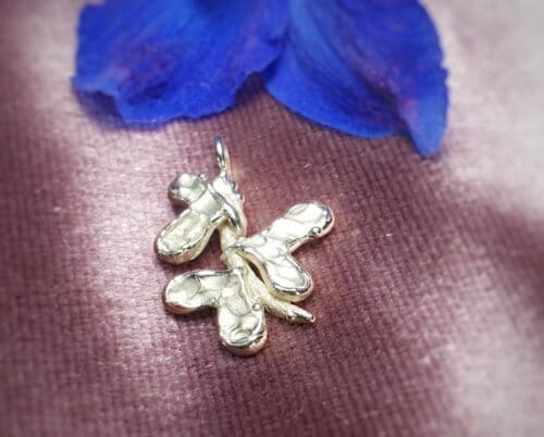 Geelgouden hanger 'Blaadjes'. Hartvormige blaadjes op een takje. Handgemaakt door Oogst Sieraden
