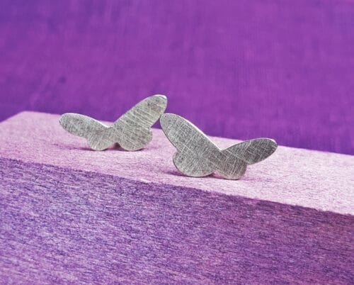 Golden ear studs from the 'Insects' series. White gold butterflies. Standout design by Oogst jewellery in Amsterdam