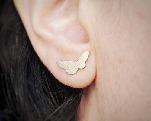 Golden ear studs from the 'Insects' series. White gold butterflies. Standout design by Oogst jewellery in Amsterdam