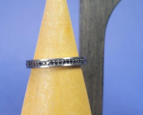 Ring Eenvoud in witgoud met zwarte diamant rondom. Maatwerk eternity ring uit het Oogst Sieraden atelier.