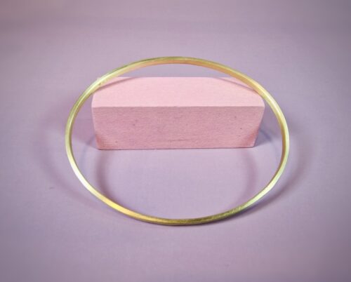Geelgouden rinkelarmband met hamerslag verlopend van fijn naar streepjes. Ovaal van vorm. Uit de Ritme serie. Verfijnd sieraad uit het Oogst atelier.