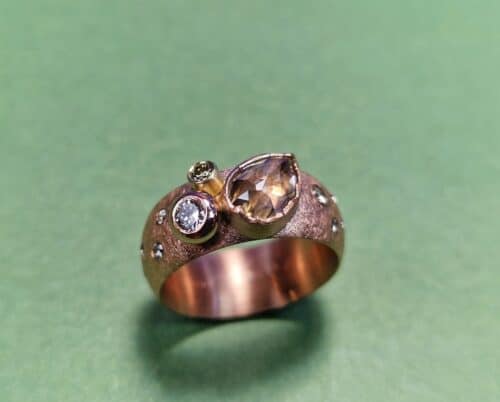 Roodgouden brede statement ring met een peervorm champagne diamant en diamanten rondom gezet. Uit de Verzameling serie. Maatwerk Oogst Original.